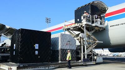 Formula One cars are unloaded at Abu Dhabi airport after making the long journey from Brazil.