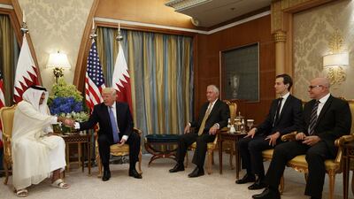 US president Donald Trump, second left, shakes hands with Qatar’s Emir Sheikh Tamim Bin Hamad Al-Thani, left, during a bilateral meeting, on Sunday, May 21, 2017, in Riyadh. Seated with them are: US secretary of state Rex Tillerson, third right, White House senior adviser Jared Kushner, second right, and US national security adviser HR McMaster. Evan Vucci / AP Photo