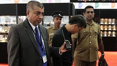 Sri Lankan authorities escort a Chinese national to the police station after he was caught swallowing at Dh50,000 diamond.