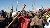 Protestors with traditional weapons and banners gather at a rally against undocumented immigrants who live in the area in Benoni, east of Johannesburg. EPA