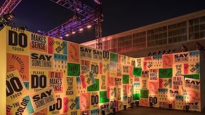 Walls covered in posters urging guests to get involved, and immerse themselves into the exhibition. Courtesy Hermès