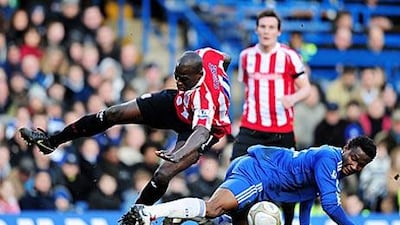 Chelsea's John Obi Mikel, right, wins the ball from Stoke's Mamady Sidibe yesterday.