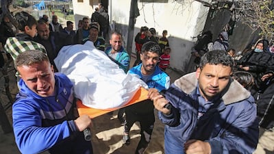 Mourners carry the body of one of the three Palestinian fishermen, who were killed when their boat exploded off Gaza's coast in the Mediterranean Sea, during their funeral in Khan Yunis in the southern Gaza Strip. AFP