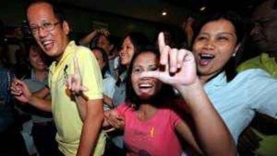 The leading presidential candidate Benigno Aquino, left, is greeted by supporters.