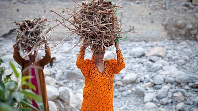 Two women return from collecting firewood. Razan Alzayani / The National