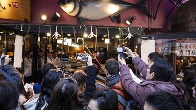 People gather outside a Sushizanmai restaurant in Tokyo, Japan. Bloomberg
