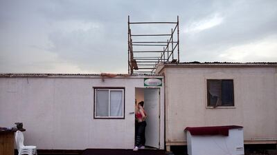 Sylvia Cramerova peeks into her family's backstage trailer.