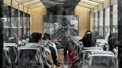 Passengers sit inside a Darjeeling Himalayan Railway steam train at a station in Darjeeling.