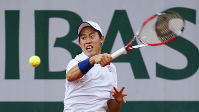 Japan's Kei Nishikori hits a return to Slovakia's Martin Klizan during their French tennis Open first round match at the Roland Garros stadium in Paris. Patrick Kovarik / AFP