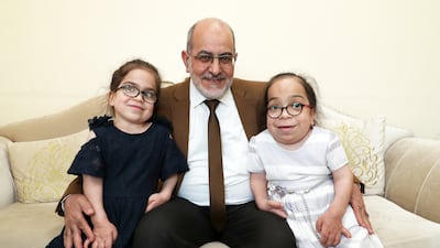 Samir Hamasha with his daughters Saba, left, and Bushra, right, who both have a rare disease called MPS 6. Pawan Singh / The National
