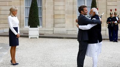 France's President Emmanuel Macron, accompanied by his wife Brigitte, welcomes India's Prime Minister Narendra Modi before a meeting at the Elysee Palace in Paris. Reuters