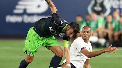 Bruno Fernandes of Sporting and Fabinho of Liverpool, right, battle for the ball. AFP