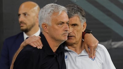 Roma manager Jose Mourinho embraces Sevilla's Jose Luis Mendilibar before kick-off. AFP