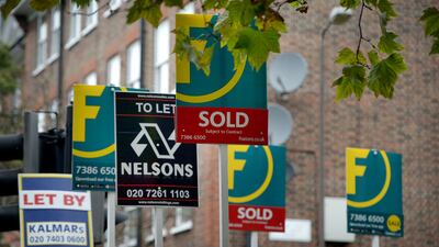 Letting and estate agents signs outside flats on the Old Kent Road in London. PA
