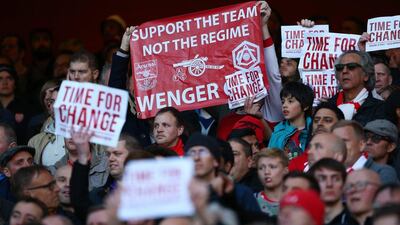 Arsenal supporters hold banners 'Time For Change' and a message for Arsene Wenger, manager of Arsenal during the Barclays Premier League match between Arsenal and Norwich City at The Emirates Stadium on April 30, 2016 in London, England Paul Gilham/Getty Images