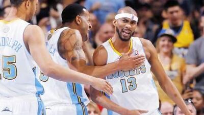 From left, Denver Nuggets forward Anthony Randolph joins guard Andre Iguodala in congratulating forward Corey Brewer after a basket. The Nuggets are relying on team play more than an individual superstar's act, as they have no big-name player.