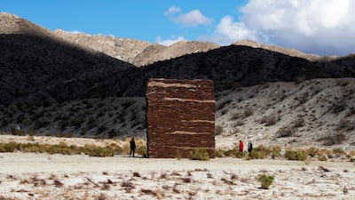Visitors look at the art installation 'What Lies Behind the Walls' by Saudi Arabian artist Zahrah Alghamdi, displayed as part of the Desert X exhibition near Palm Springs, California. EPA