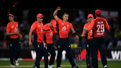 England bowler Tom Curran, centre, celebrates taking the wicket of Martin Guptill. Getty