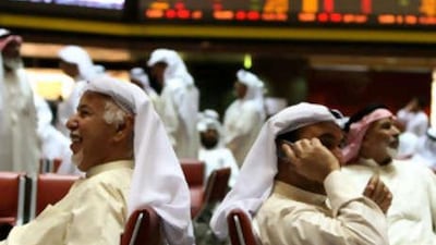 Kuwaiti traders follow the market's movement at the Stock Exchange in Kuwait City on Sept 21 2008.