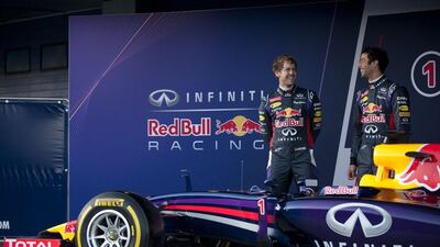 Sebastian Vettel and Daniel Ricciardo with the new Infiniti-Redbull Racing RB10 racing car on Tuesday. Jorge Guerrero / AFP