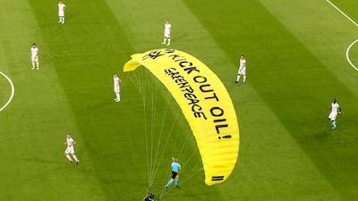 The German players look on as a Greenpeace paraglider lands in the Allianz Arena stadium in Munich. AP Photo