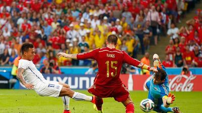 Eduardo Vargas of Chile shoots and scores his team's first goal past Sergio Ramos and goalkeeper Iker Casillas of Spain during their match on Wednesday at the 2014 World Cup in Rio de Janeiro, Brazil. Clive Rose / Getty Images