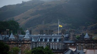 The Lion Rampart flag at half-mast above the Palace of Holyroodhouse in Edinburgh, where Queen Elizabeth's body will be driven on Sunday. Bloomberg
