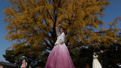 Tourists dressed in traditional Korean clothing pose for photos while visiting Gyeongbokgung Palace in Seoul, South Korea. EPA