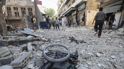 A wheelchair amid the rubble of destroyed buildings following a regime air strike on the town of Ariha, in southern Idlib. AFP / Omar Haj Kadour