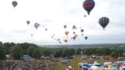 Spectators watch as hot-air balloons take off during a mass launch at the Bristol International Balloon Fiesta. Reuters