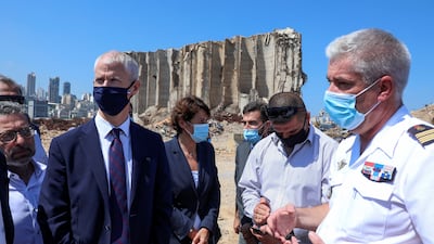 French Foreign Trade Minister Franck Riester, right and the French Ambassador to Lebanon Anne Grillo, visit Beirut's port, devastated in a massive deadly explosion in August last year. AP