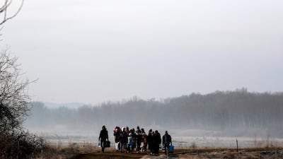 Migrants walk along the Evros river to reach Greece, near the Turkish border city of Edirne, Turkey. Reuters