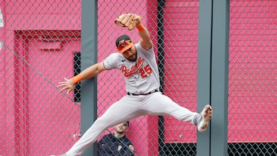 Baltimore Orioles right fielder Anthony Santander runs into a fence as he unsuccessfully tries to catch a two-run home run by Kansas City Royals' Salvador Perez during a baseball game in Kansas City, Missouri. AP