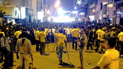 Indian police personnel holding 'lathi' sticks try to manage crowds during New Year's Eve celebrations in Bangalore on January 1, 2017. An Indian minister faced a severe backlash January 3 after he criticised women for dressing "like westerners" at a New Year's Eve celebration where a mob allegedly carried out a series of sex assaults. Photo: AFP