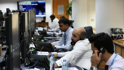Traders at the National Bank of Fujairah office in Dubai. Longer hours don't necessarily lead to greater productivity. (Pawan Singh / The National)