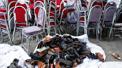 The shoes of victims are seen outside a damaged wedding hall after a blast in Kabul, Afghanistan. Reuters