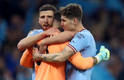 Manchester City players John Stones, Ederson and Ruben Dias celebrate victory over Real Madrid in the Champions League semi finals. EPA