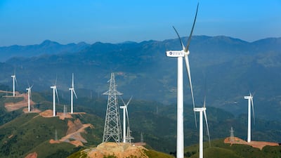 Wind turbines manufactured by Mingyang Electric whirl to generate electricity at a wind farm on the outskirts of Xinyi city, south China's Guangdong province. AP