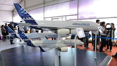 Visitors gather around Airbus A320 and A380 aircraft scale models. Libyan Wings aims to buy aircraft from the A320 family. Noah Seelam / AFP