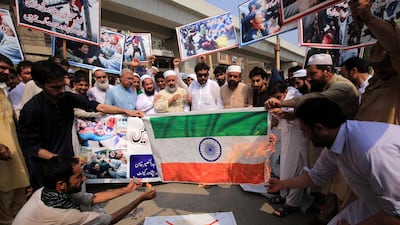 People burn an Indian flag during a protest in Peshawar, Pakistan. EPA