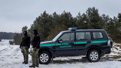 Polish border guard officers patrol their country's border with Belarus on January 25, 2022. AFP
