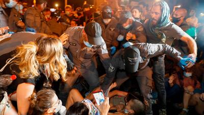 Israeli police evacuate protestors blocking a main road during a demonstration against the Israeli prime minister outside his official residence in Jerusalem. AFP