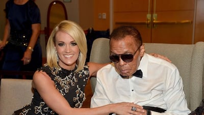 This file photo taken on April 8, 2016 shows Muhammad Ali Celebrity Fight Night Award honoree Carrie Underwood, left, and Muhammad Ali attending Muhammad Ali’s Celebrity Fight Night XXII at the JW Marriott Phoenix Desert Ridge Resort & Spa in Phoenix, Arizona. Charley Gallay / Getty Images North America / AFP