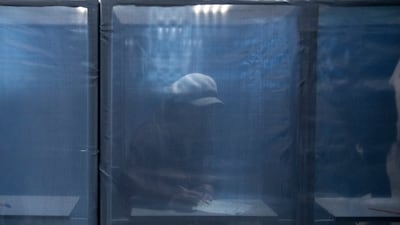 A woman fills in a ballot paper at a polling station in the Russian-controlled Donetsk region of eastern Ukraine. AP