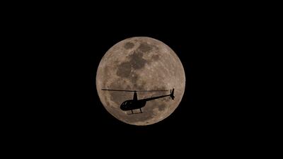 A helicopter in front of the blue supermoon in the city of Sao Paulo. EPA