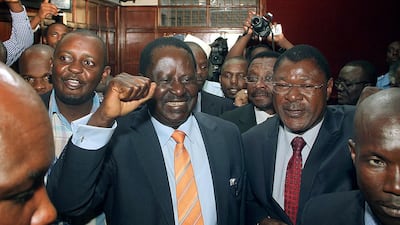 Kenyan opposition leader Raila Odinga, centre, walks out of the high court in Nairobi on January 2, 2015, after it suspended key parts of the controversial new security law. AFP