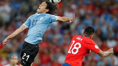 Edinson Cavani of Uruguay in action against Jara of Chile. EPA