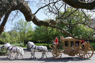 All aboard as four white horses pull the replica carriage in London's Dulwich Park. Reuters