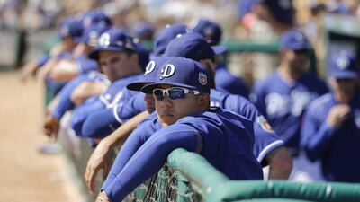 Los Angeles Dodgers starting pitcher Julio Urias watches the team from the dugout during a spring training game last week. Jae C Hong / AP / March 14, 2016