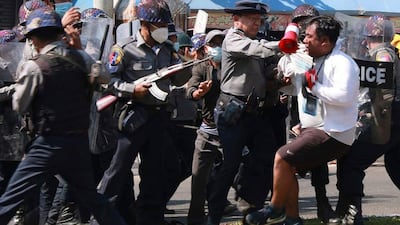 Police arrest a protester during a demonstration against the military coup in Mawlamyine in Mon State. AFP